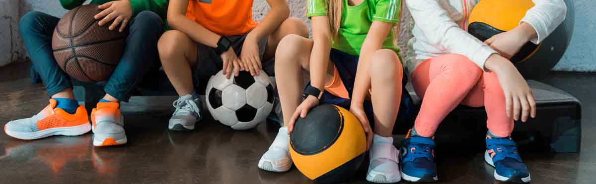 Kids sitting down in gym attire